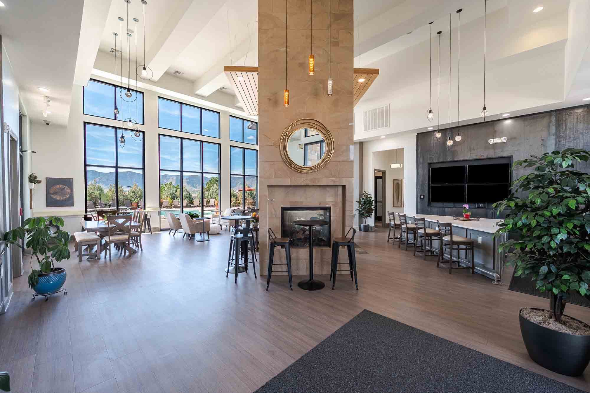 Vistas at Jackson Creek clubhouse interior with soaring ceilings, fireplace, and natural light