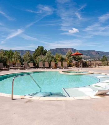 Vistas at Jackson Creek sparkling swimming pool surrounded by landscaping with mountain views