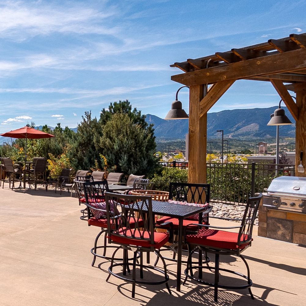 Vistas at Jackson Creek outdoor dining area with wooden pergola and mountain views