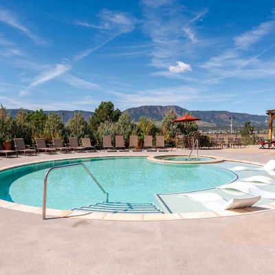 Vistas at Jackson Creek sparkling swimming pool surrounded by landscaping with mountain views
