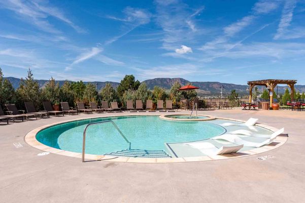 Vistas at Jackson Creek sparkling swimming pool surrounded by landscaping with mountain views