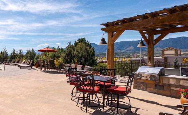 Vistas at Jackson Creek outdoor dining area with wooden pergola and mountain views